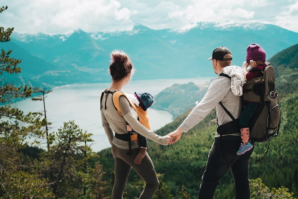 Family hiking together above a mountain lake