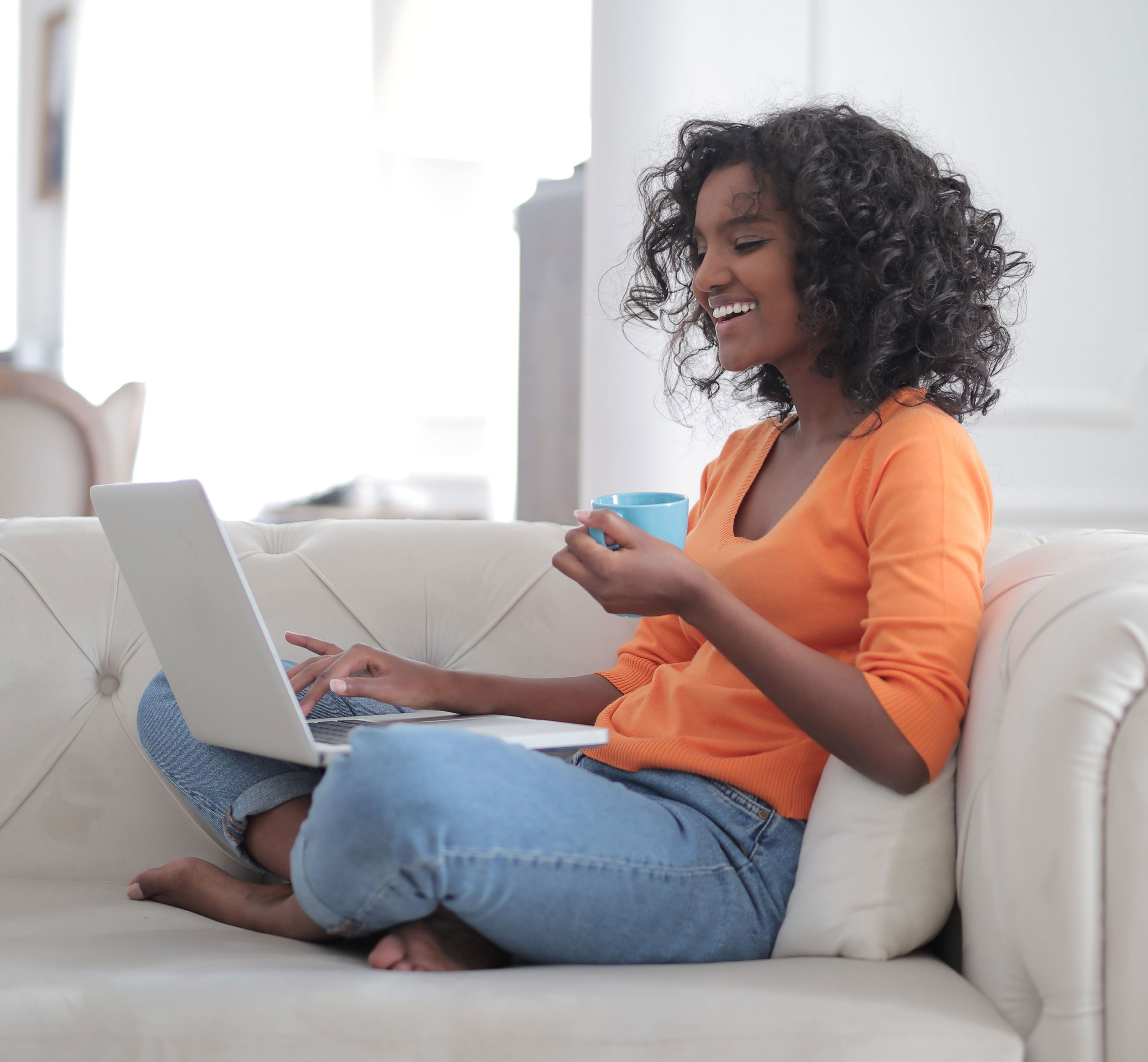 Woman relaxing at home with a cup of coffee during a Zoom session